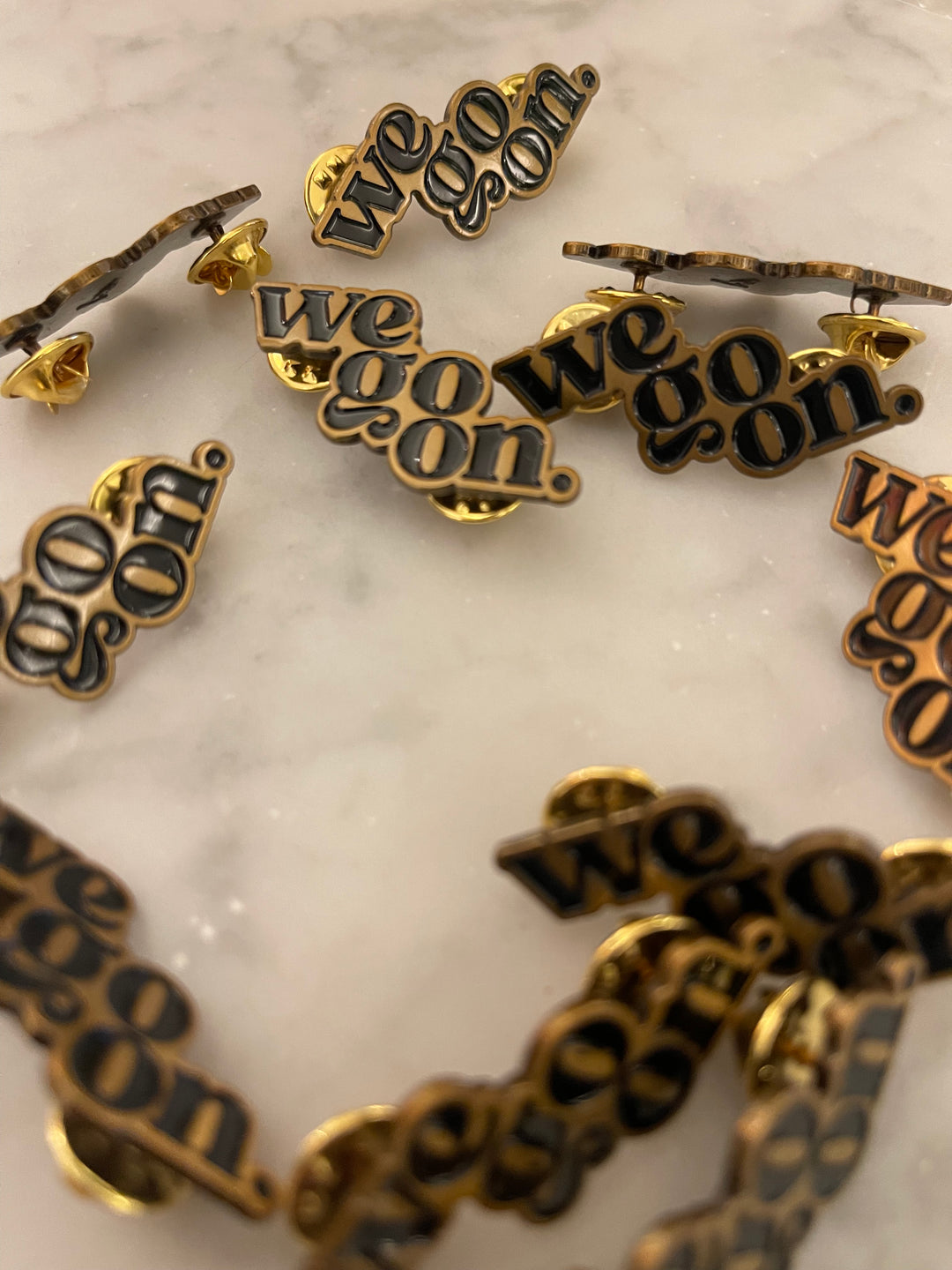 We Go On Lapel Pin